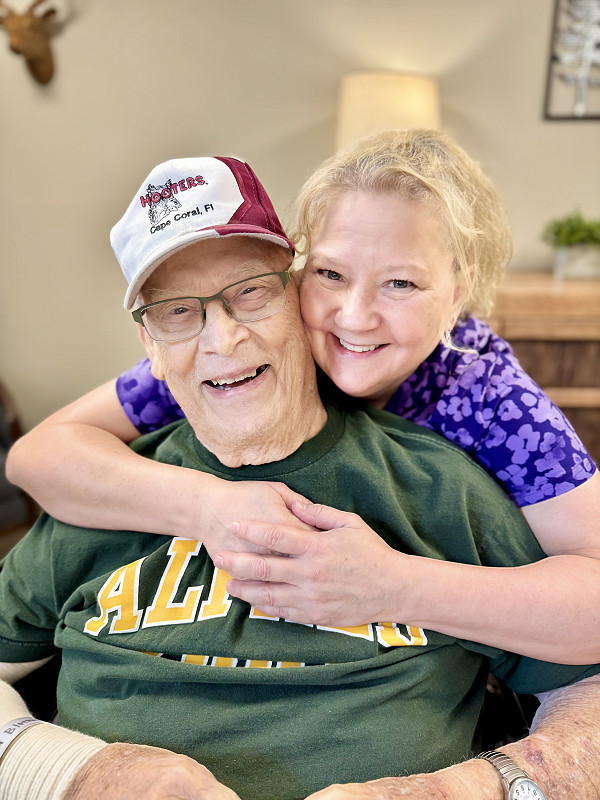 A Rocky Knoll staff member poses with a resident